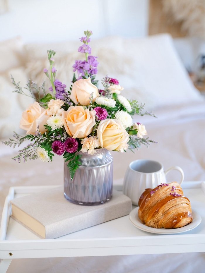 Spring flowers in lavender vase